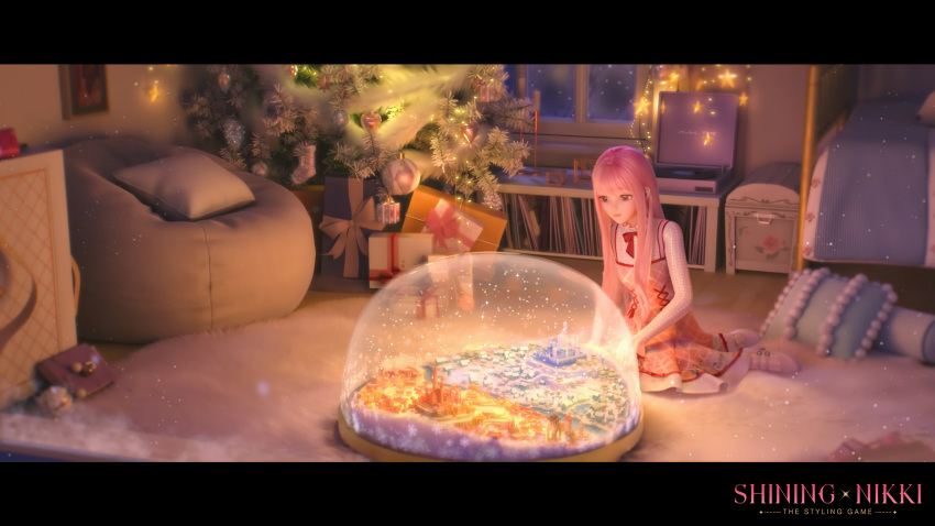 1girl bag bed brown_eyes building carpet christmas_tree city copyright_name dress english_commentary highres indoors long_hair looking_at_object miniature night nikki_(miracle_nikki) official_art official_wallpaper on_floor picture_(object) pink_dress pink_hair red_ribbon ribbon shining_nikki shirt sitting snow snow_globe snowflakes snowing white_footwear white_shirt