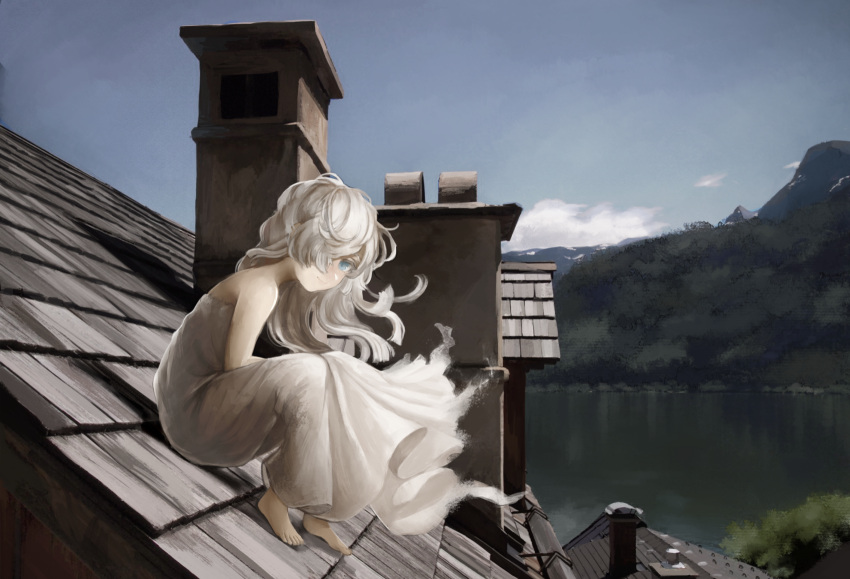 1girl barefoot blue_eyes blue_sky blush chimney commentary day dress fantasy floating_hair foliage from_side full_body hair_over_one_eye highres ito_(silva) knees_up lake long_hair looking_at_viewer looking_to_the_side mountainous_horizon on_roof one_eye_covered original outdoors scenery sitting sitting_on_roof sky smile solo strapless strapless_dress tile_roof white_dress white_hair wind