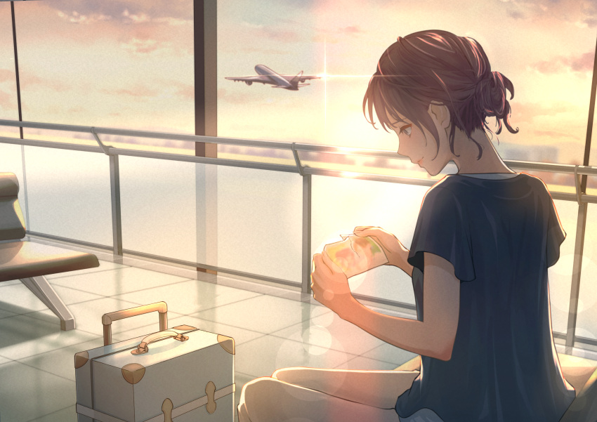 1girl absurdres aircraft airplane blue_shirt brown_hair closed_mouth clouds commentary_request feet_out_of_frame grey_eyes hair_bun highres holding indoors macaronk original pants profile shirt short_sleeves sitting sky smile suitcase sunset white_pants window