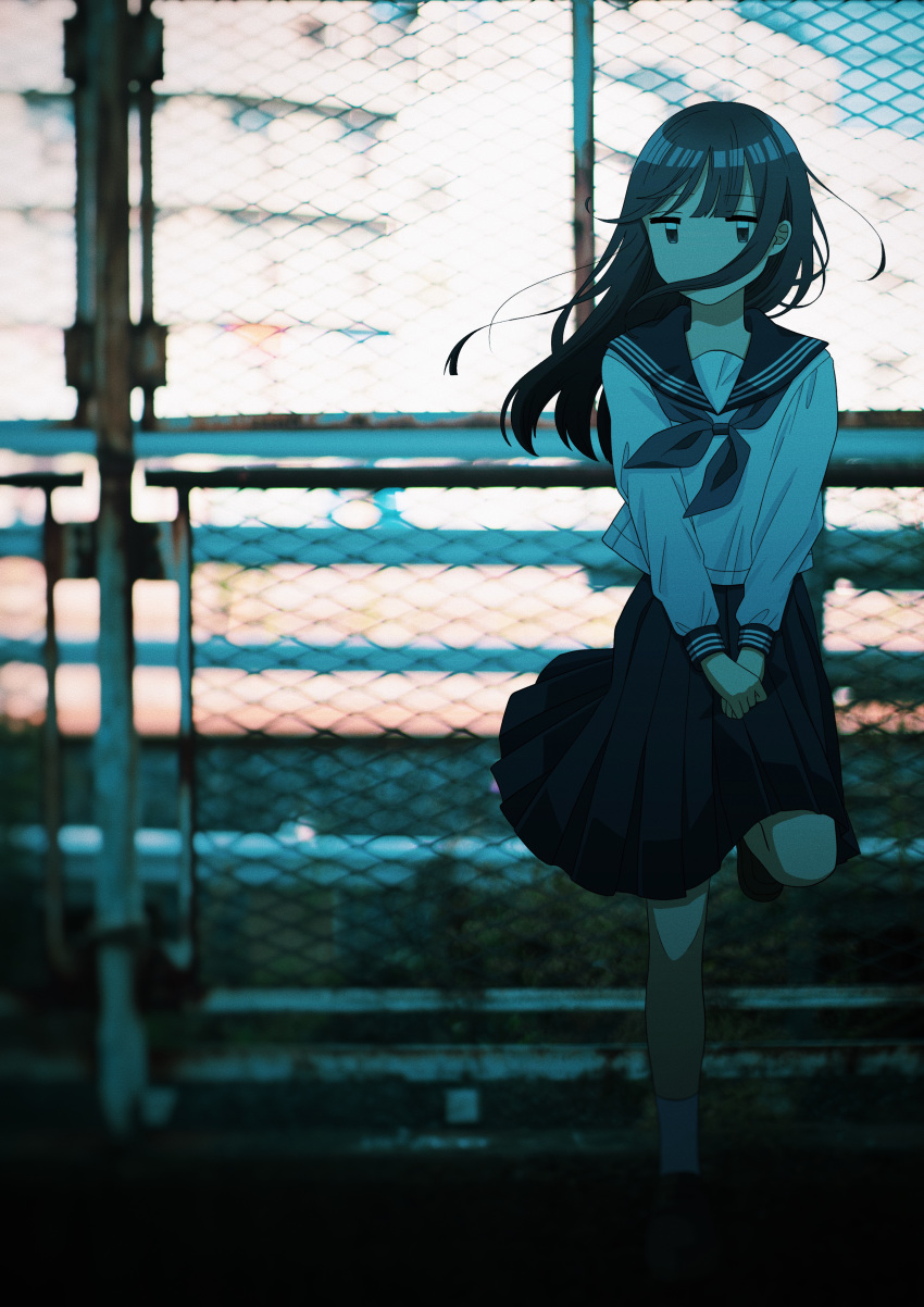 1girl absurdres black_eyes black_footwear black_hair black_sailor_collar black_skirt building chain-link_fence commentary_request day fence full_body hair_over_mouth highres long_hair long_sleeves looking_at_viewer original outdoors photo_background pleated_skirt sailor_collar school_uniform serafuku shirt skirt socks solo tsuzuki_amy white_shirt white_socks