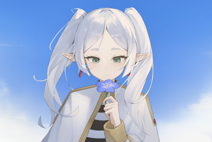 1girl blue_sky capelet closed_mouth commentary earrings elf flower frieren gmi_(jimmyovob) green_eyes hand_up highres holding holding_flower jewelry long_hair looking_at_object pointy_ears short_eyebrows sky solo sousou_no_frieren straight-on symbol-only_commentary twintails upper_body white_capelet white_hair