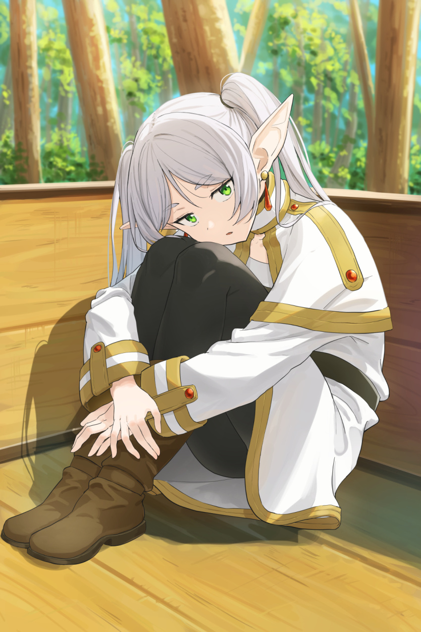 1girl black_pants boots brown_footwear earrings elf forest frieren full_body green_eyes highres jewelry kamo_ashi long_hair long_sleeves looking_at_viewer nature pants pointy_ears sitting solo sousou_no_frieren tree twintails white_hair