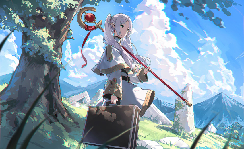 1girl belt belt_buckle black_belt blue_sky buckle capelet closed_mouth clouds day elf floating_hair frieren gold_trim grass green_eyes highres holding holding_staff holding_suitcase long_hair long_sleeves looking_at_viewer mage_staff mountainous_horizon outdoors parted_bangs pointy_ears rock shadow shirt skirt sky solo sousou_no_frieren staff suitcase tree twintails white_capelet white_hair white_shirt white_skirt yohaku