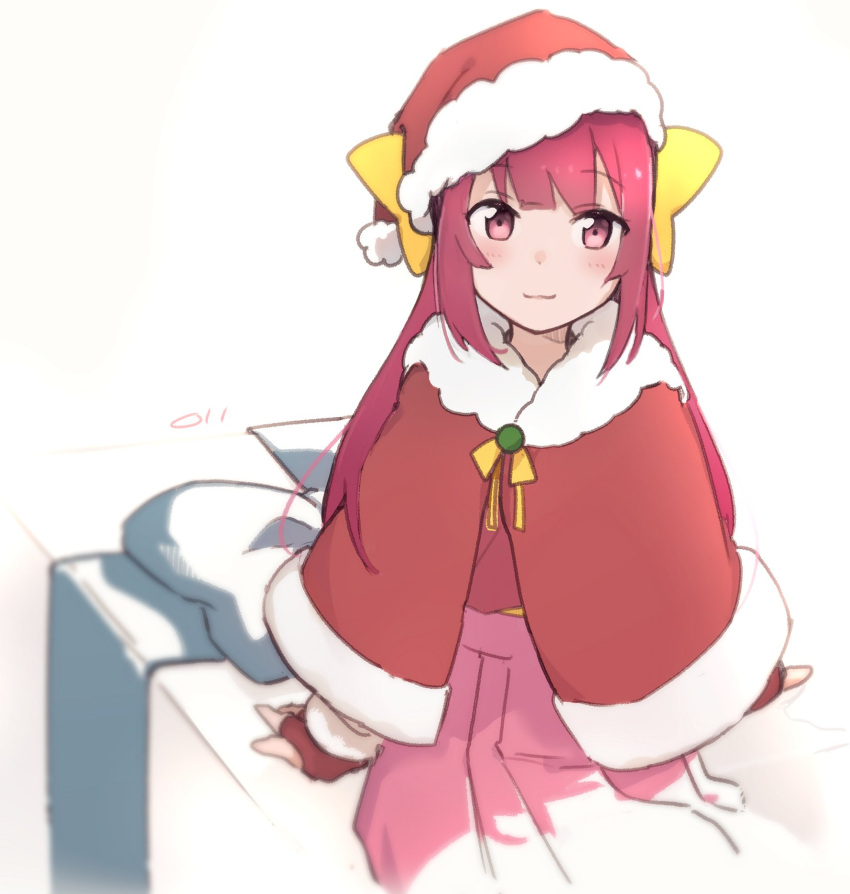 1girl bed bow capelet cowboy_shot fur-trimmed_capelet fur-trimmed_headwear fur_trim hair_bow hakama hat highres japanese_clothes kamikaze_(kancolle) kantai_collection long_hair ma_rukan pink_hakama red_capelet red_eyes red_headwear redhead santa_hat smile solo yellow_bow