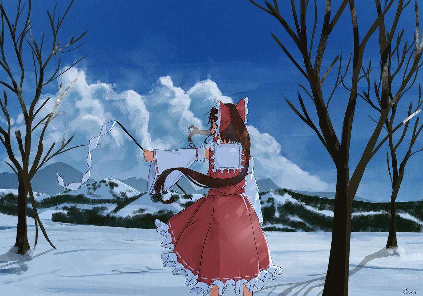 1girl absurdres bow brown_hair detached_sleeves frilled_skirt frills from_behind gohei hair_bow hakurei_reimu highres holding holding_gohei long_hair nontraditional_miko ourie red_bow red_shirt red_skirt shirt skirt sleeveless sleeveless_shirt snow solo touhou tree wide_sleeves winter