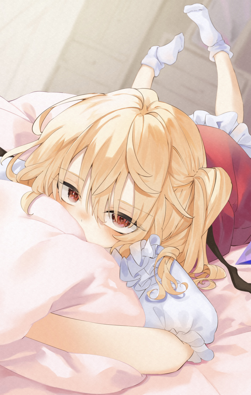 absurdres blonde_hair blush calpis118 covered_mouth feet_up flandre_scarlet highres hugging_object indoors looking_at_viewer lying on_stomach one_side_up pillow pillow_hug red_eyes socks touhou white_socks