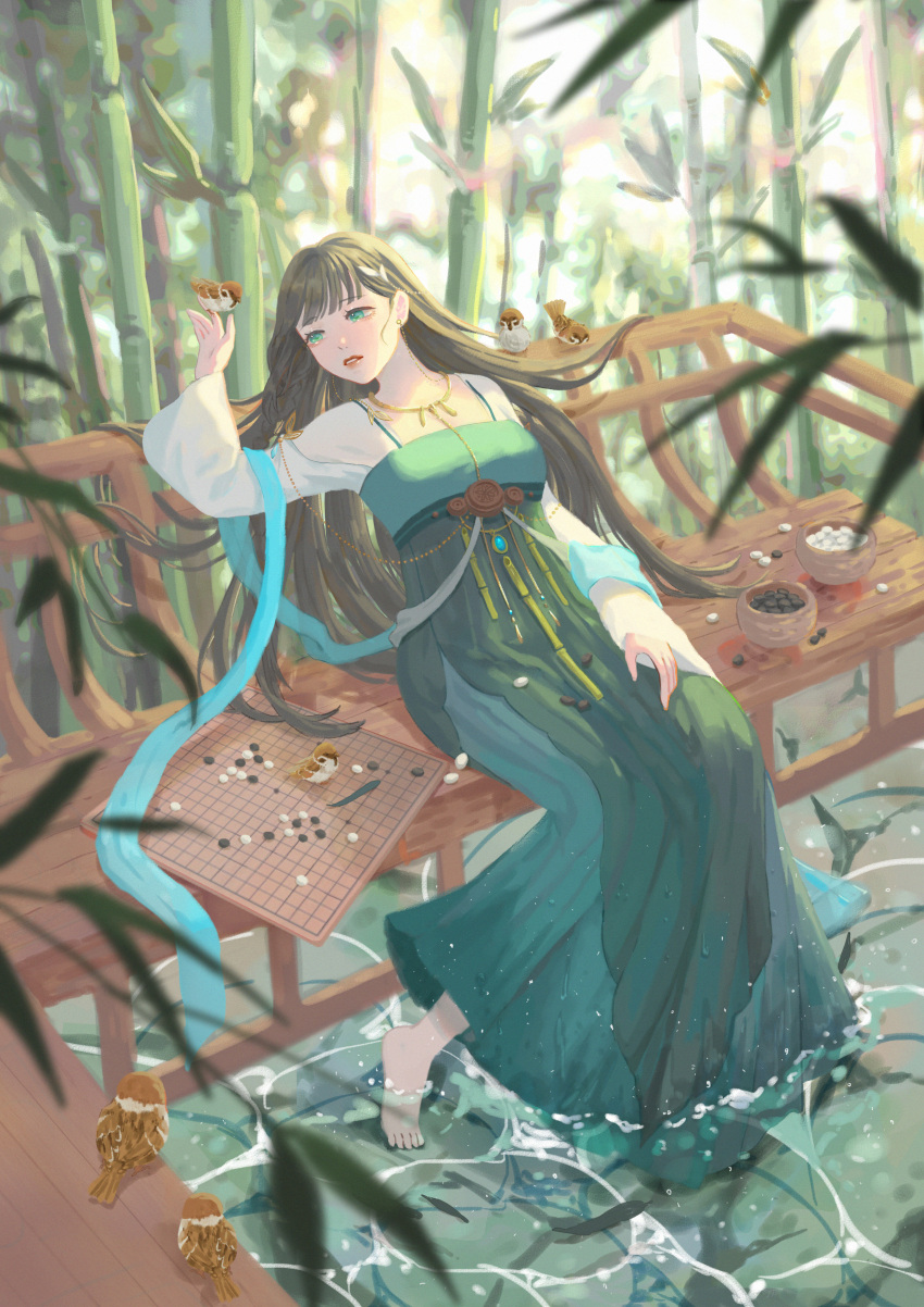 1girl absurdres bamboo barefoot bench bird black_hair board_game day dress go_(board_game) green_dress green_eyes highres jewelry leaf liliantsai0417 long_hair long_sleeves necklace original outdoors parted_lips plant soaking_feet solo very_long_hair water wide_shot