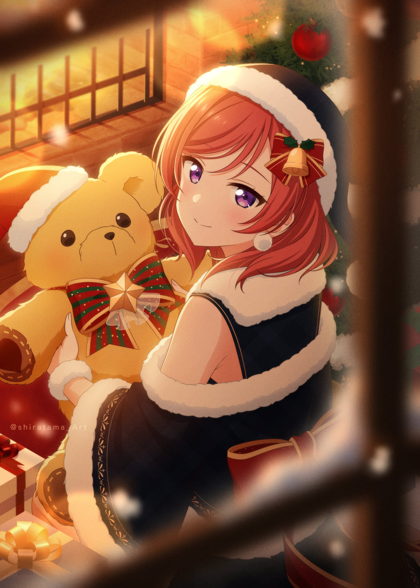 1girl absurdres back_bow blurry blurry_foreground bow bowtie box christmas_tree closed_mouth fireplace fur_trim gift gift_box hat highres indoors looking_at_viewer looking_back love_live! nishikino_maki off_shoulder official_style redhead santa_hat shiratama_(siratama_ll) smile solo stuffed_animal stuffed_toy teddy_bear twitter_username violet_eyes window