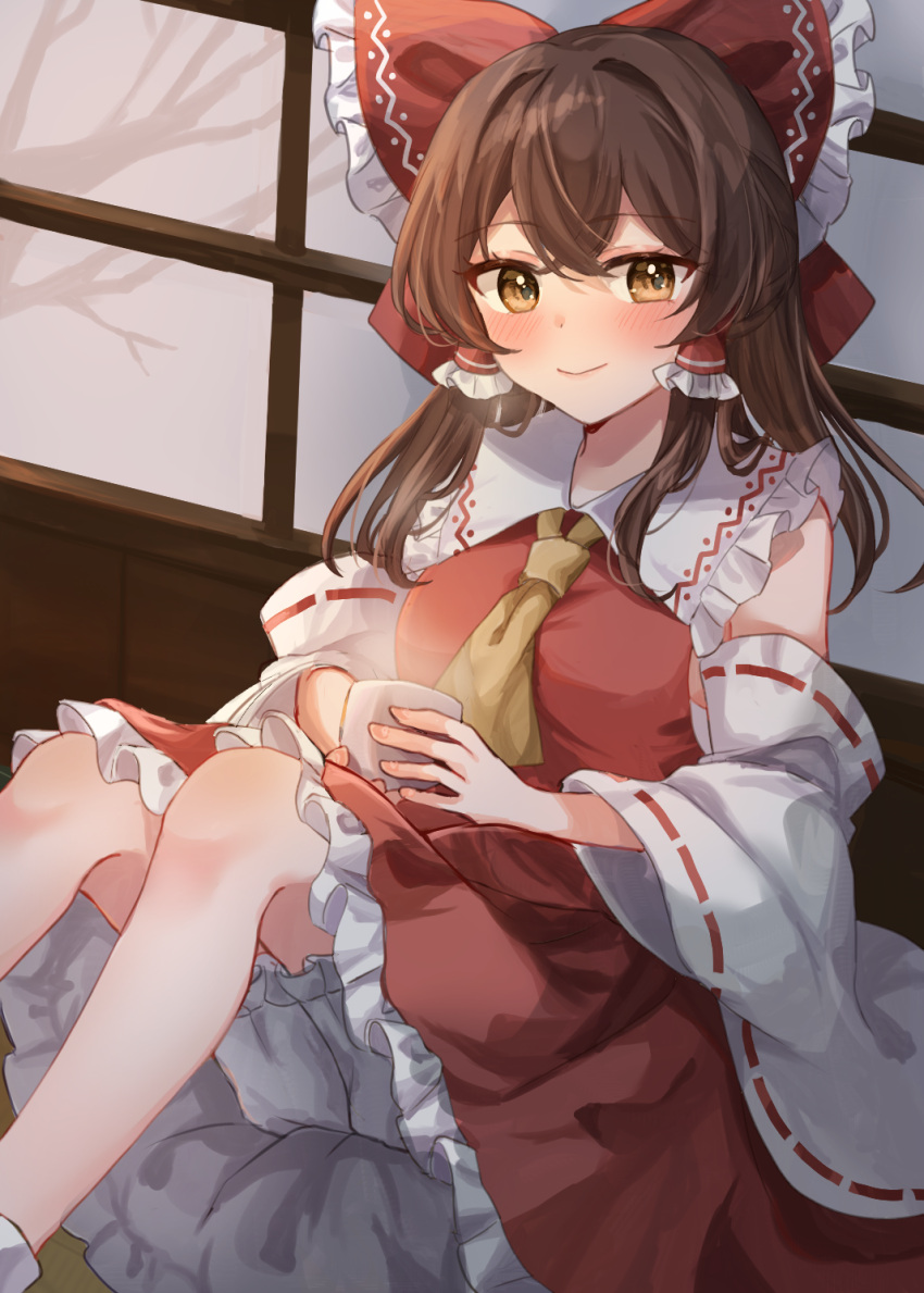 1girl ascot bloomers blush bow brown_eyes brown_hair closed_mouth commentary_request crossed_bangs cup detached_sleeves double-parted_bangs eyelashes feet_out_of_frame frilled_bow frilled_hair_tubes frilled_shirt_collar frilled_skirt frills hair_between_eyes hair_bow hair_tubes hakurei_reimu highres holding holding_cup huge_bow ikeyan0677 indoors knees_up long_hair long_sleeves looking_at_viewer nontraditional_miko red_bow red_shirt red_skirt ribbon-trimmed_sleeves ribbon_trim shirt sitting skirt smile solo steam touhou tsurime white_bloomers wide_sleeves yellow_ascot