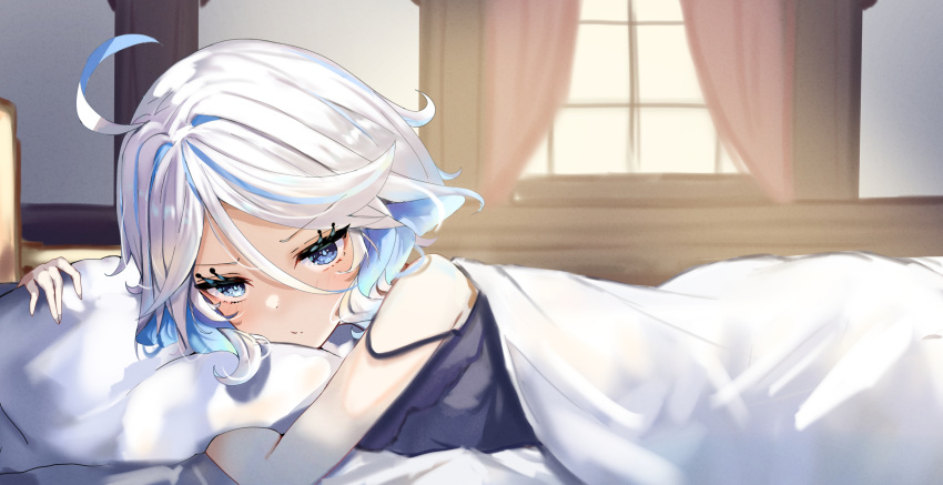 1girl ahoge bare_arms bimmy black_camisole blue_eyes blue_hair camisole closed_mouth commentary curtains furina_(genshin_impact) genshin_impact hair_between_eyes heterochromia highres indoors long_hair looking_at_viewer lying multicolored_hair on_stomach pillow solo two-tone_hair under_covers white_hair window