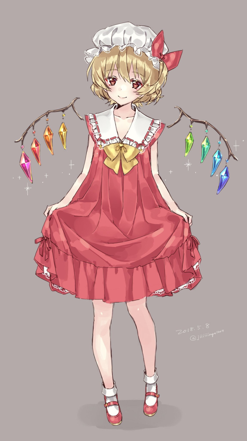 1girl adapted_costume bow bowtie closed_mouth collarbone crystal dated dress flandre_scarlet frilled_shirt_collar frills full_body grey_background hair_between_eyes happy hat head_tilt highres jiinyo_(awamoe1207) light_smile looking_at_viewer mary_janes mob_cap multicolored_wings one_side_up red_dress red_eyes red_footwear shoes short_hair skirt_hold socks solo touhou twitter_username white_headwear white_socks wings yellow_bow yellow_bowtie