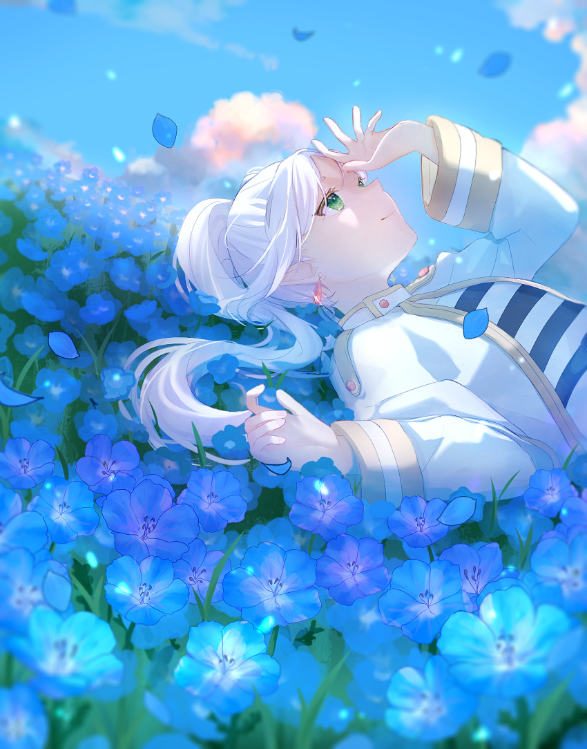 1girl blue_flower blue_sky blurry closed_mouth clouds commentary depth_of_field dress drop_earrings earrings falling_petals field flower flower_field frieren green_eyes hand_up highres jewelry long_hair long_sleeves looking_up lying on_back outdoors petals shiromi sky smile solo sousou_no_frieren symbol-only_commentary twintails upper_body white_dress white_hair