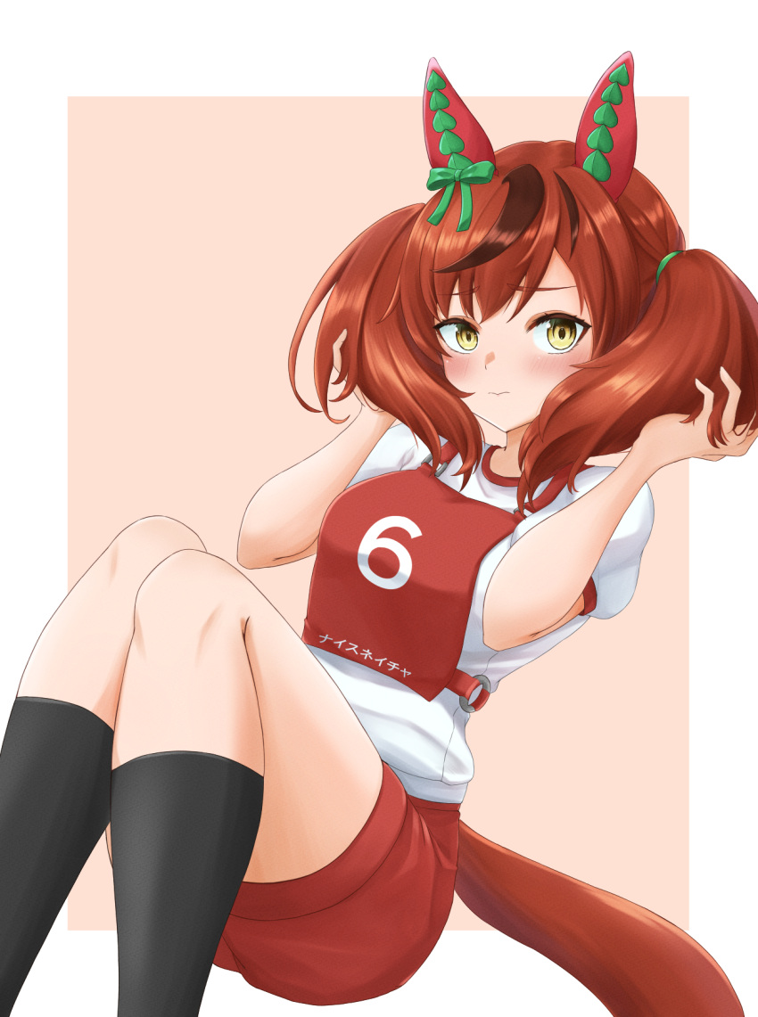 1girl animal_ears black_socks blush brown_eyes brown_hair character_name closed_mouth commentary ear_covers gym_shirt gym_shorts gym_uniform hair_tie hands_in_own_hair highres horse_ears horse_girl kemuri_(etep3372) light_frown looking_at_viewer medium_hair multicolored_hair nice_nature_(umamusume) pink_background race_bib red_shorts shirt short_sleeves shorts sitting socks solo streaked_hair translated twintails umamusume white_shirt