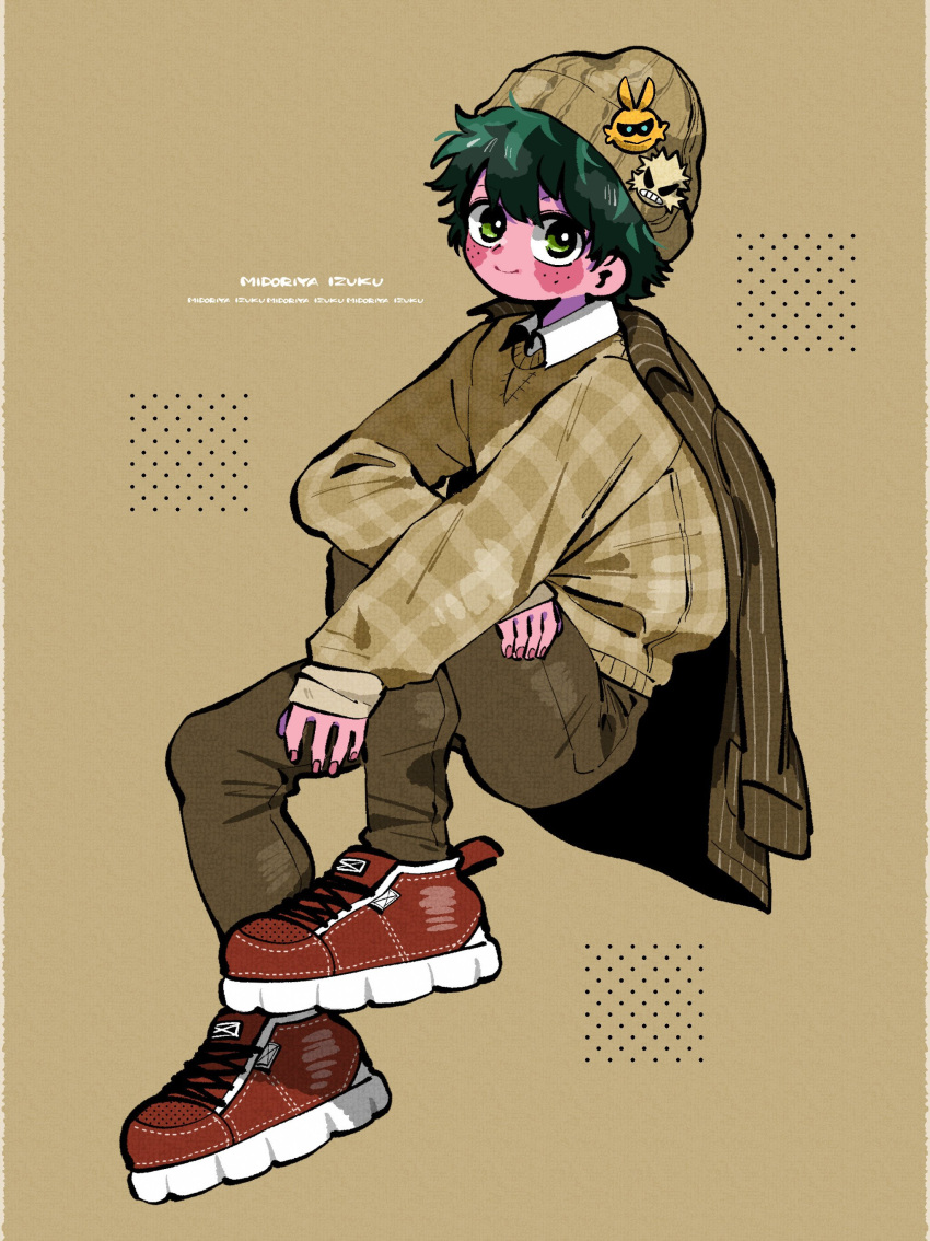 1boy absurdres all_might alternate_costume alternate_skin_color anna_(aannnaa3) arm_on_knee arm_rest bakugou_katsuki beanie blush boku_no_hero_academia brown_pants casual character_name character_sticker closed_mouth collared_shirt colored_skin commentary cross-laced_footwear eyebrows_hidden_by_hair fingernails freckles from_side full_body green_eyes green_hair hair_between_eyes hands_up hat highres invisible_chair jacket jacket_on_shoulders knee_up light_brown_background looking_at_viewer looking_to_the_side male_focus midoriya_izuku outstretched_arm pants pink_nails pink_skin plaid plaid_sweater polka_dot red_footwear shirt shoes short_hair sitting sleeves_past_wrists smile sneakers solo split_mouth sticker sweater white_shirt wing_collar
