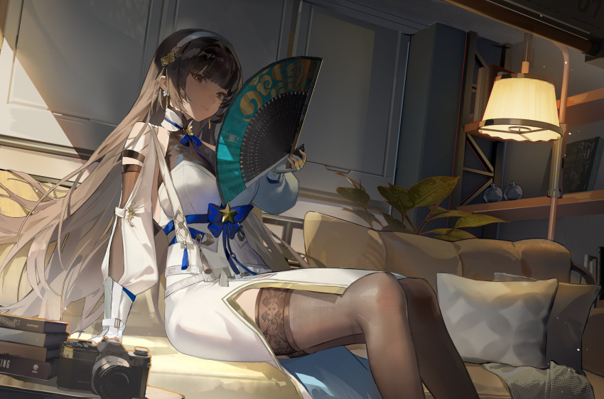 1girl absurdres black_thighhighs blue_bow book book_stack bookshelf bow brand_name_imitation breasts brown_hair camera chinese_clothes coach folding_fan girls'_frontline_2:_exilium girls_frontline hand_fan highres holding holding_fan jiojio lamp long_hair looking_at_viewer orange_eyes pillow sitting solo thigh-highs type_95_(girls'_frontline) vegetation