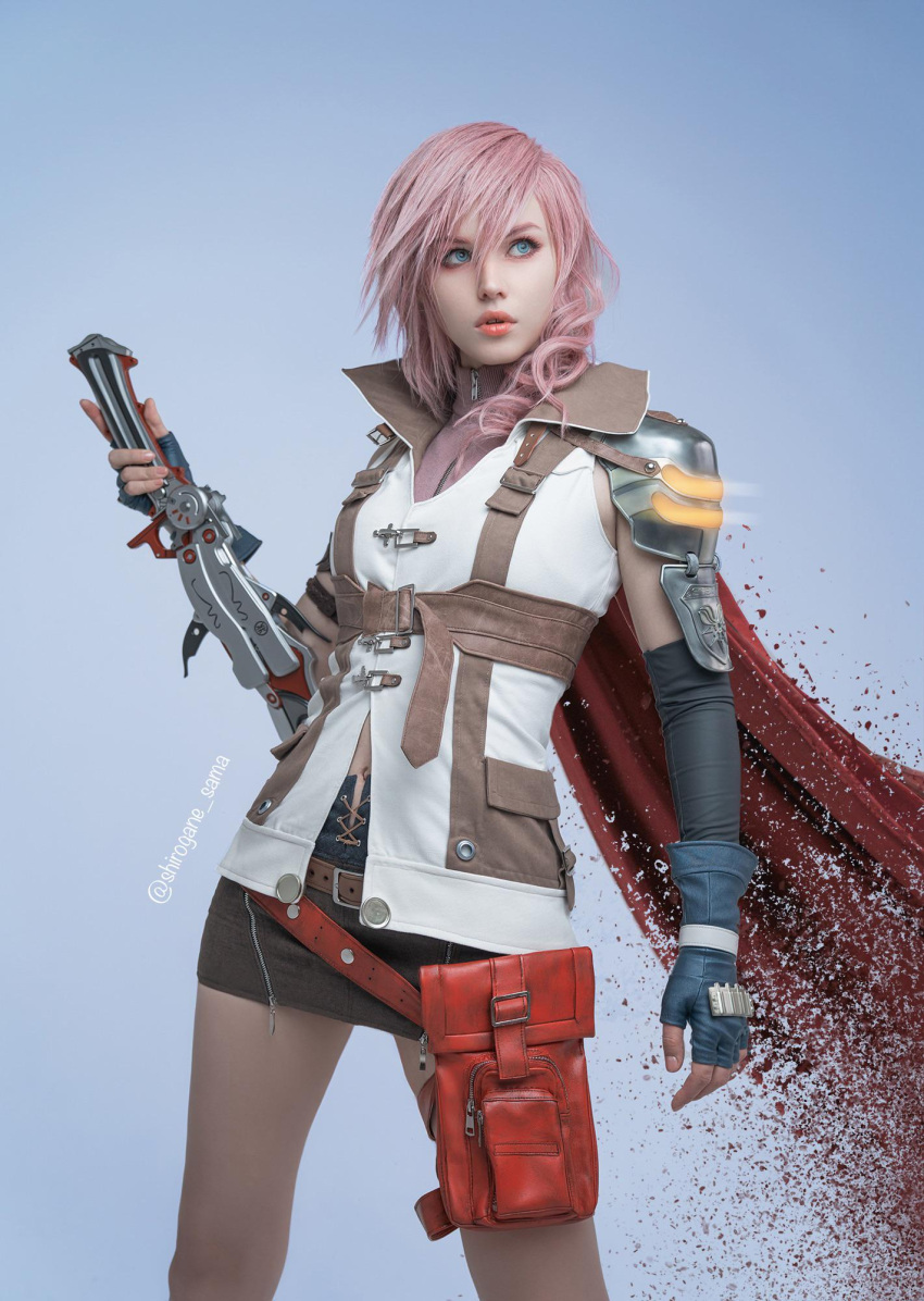 1girl belt blazefire_saber blue_background blue_eyes blue_gloves brown_belt brown_skirt brown_sweater cape cosplay_photo dissolving english_commentary eyeshadow final_fantasy final_fantasy_xiii fingerless_gloves gloves glowing highres holding holding_sword holding_weapon jacket leaning_back lightning_farron looking_up makeup medium_hair navel parted_lips photo_(medium) pink_eyeshadow pink_hair red_cape shirogane-sama skirt sleeveless sleeveless_jacket solo sweater sword twitter_username weapon white_jacket