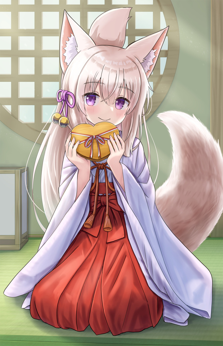 1girl absurdres animal_ear_fluff animal_ears blush box brown_hair closed_mouth commentary_request folded_ponytail fox_ears fox_girl fox_tail gift gift_box hair_between_eyes hakama hakama_skirt hands_up heart-shaped_box highres holding holding_gift indoors iroha_(iroha_matsurika) japanese_clothes kimono koyoi_(iroha_(iroha_matsurika)) long_hair long_sleeves looking_at_viewer miko on_floor original red_hakama round_window seiza sitting skirt smile solo tail tatami valentine very_long_hair violet_eyes white_kimono wide_sleeves window