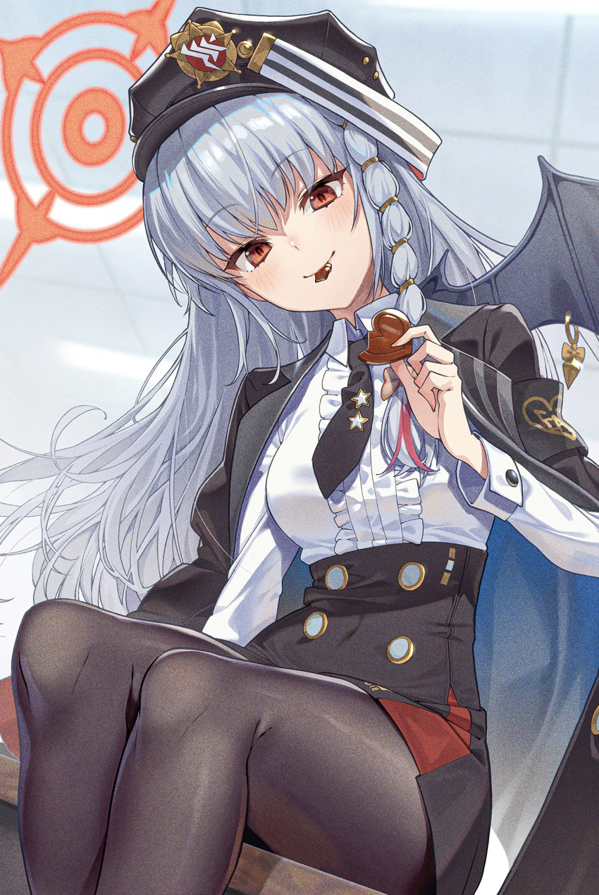 1girl black_necktie black_pantyhose black_skirt black_wings blue_archive blush braid candy chocolate closed_mouth collared_shirt demon_wings fake_wings feet_out_of_frame food grey_hair haruna_(blue_archive) heart heart-shaped_chocolate highres holding holding_chocolate holding_food kabu_(niniko2ko) long_hair long_sleeves looking_at_viewer necktie pantyhose red_eyes shirt side_braid single_wing sitting skirt smile solo white_shirt wings