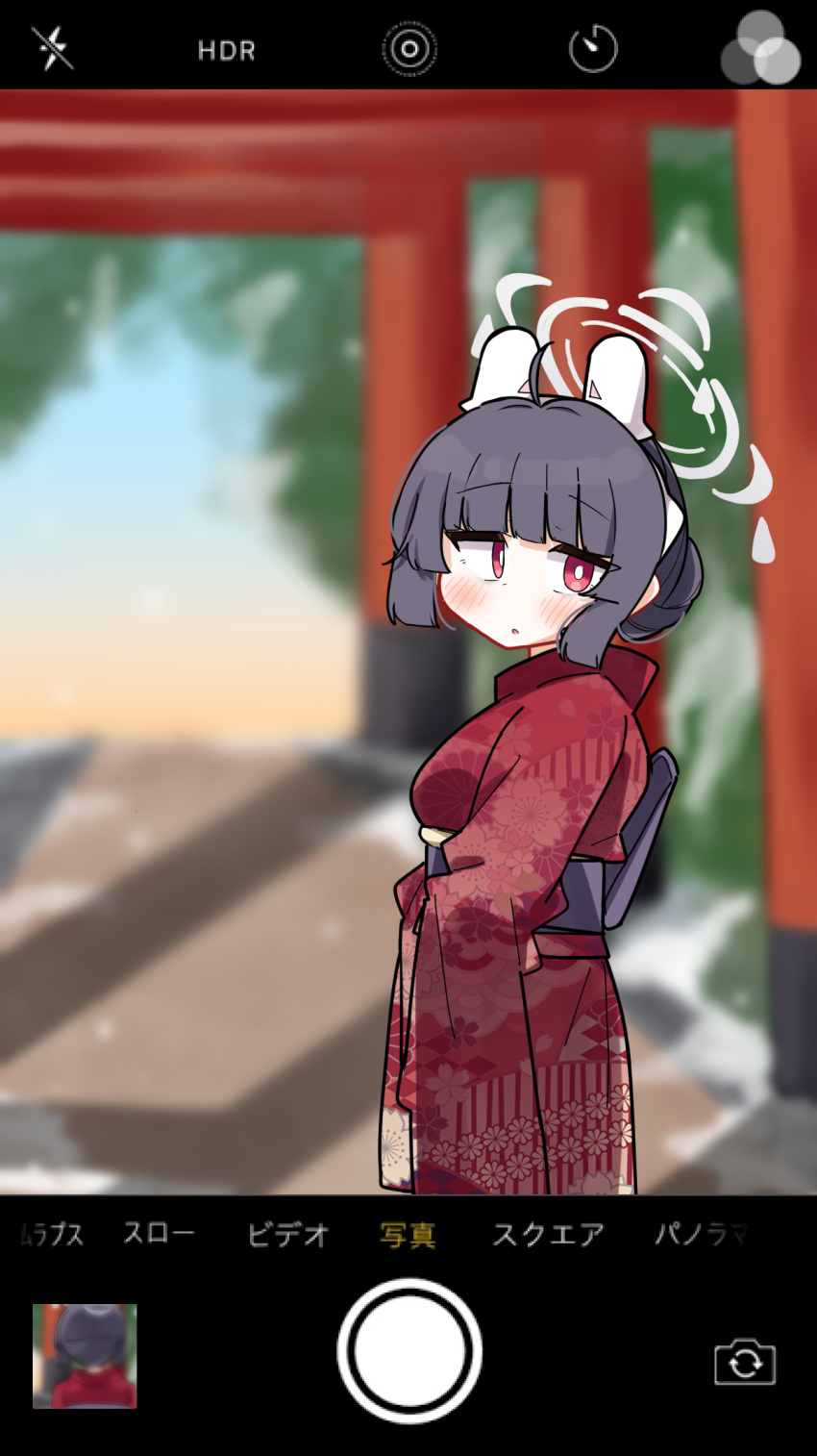 1girl :o ahoge black_hair blue_archive blurry blurry_background blush cellphone_display dash_b day depth_of_field floral_print hair_bun halo headgear highres japanese_clothes kimono looking_at_viewer looking_to_the_side miyu_(blue_archive) outdoors parted_lips print_kimono red_eyes red_kimono solo torii