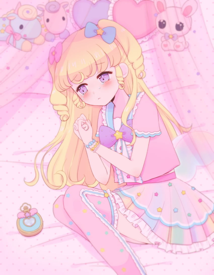 1girl blonde_hair blush bow bracelet center_frills closed_mouth curtains feet_out_of_frame frilled_skirt frills frown hair_bow hair_ornament heart heart-shaped_pillow highres hoshikuzu_(pinkholic) idol_clothes idol_time_pripara jewelry long_hair looking_down lying on_bed on_side own_hands_together pillow pink_bow pink_shirt pink_skirt pink_thighhighs pretty_series pripara ringlets sad shirt skirt solo star_(symbol) star_hair_ornament stuffed_animal stuffed_rabbit stuffed_toy stuffed_unicorn tearing_up thigh-highs two_side_up violet_eyes yumekawa_yui