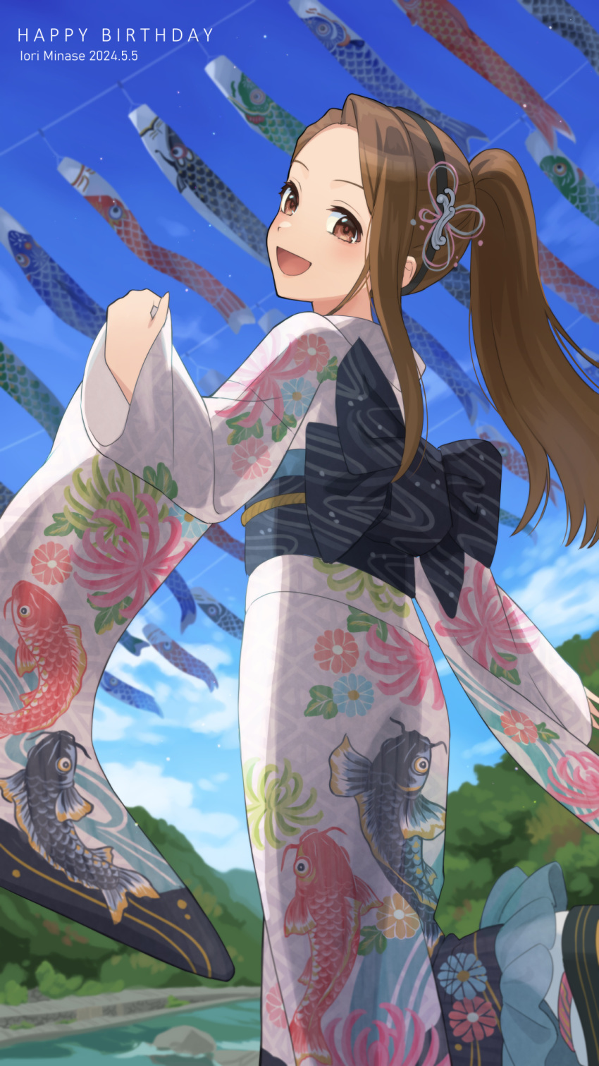 1girl :d animal_print asymmetrical_bangs black_hairband blue_sky blush brown_hair character_name clouds cloudy_sky dated dot_nose fish_print floral_print_kimono forehead from_behind fukakuteisei hair_ornament hairband happy_birthday highres idolmaster idolmaster_(classic) idolmaster_million_live! idolmaster_million_live!_theater_days japanese_clothes kimono koinobori long_hair long_sleeves looking_at_viewer looking_back minase_iori obi obijime official_alternate_hairstyle open_mouth outdoors ponytail print_kimono river sash single_sidelock sky smile solo standing tree windsock