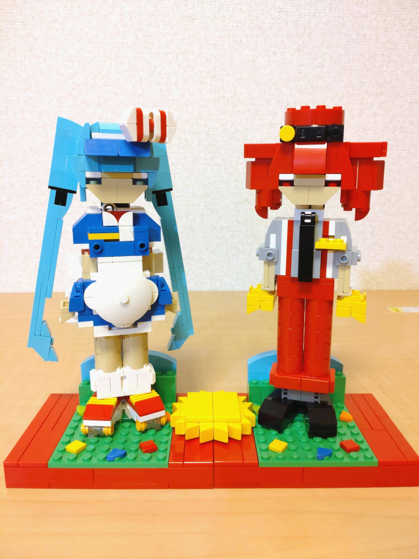 2girls alternate_costume apron arms_at_sides black_footwear black_necktie blue_dress blue_eyes blue_hair bow choroli_(chorolin) commentary dress drill_hair full_body gloves grey_shirt hair_bow hat hatsune_miku highres kasane_teto lego_(medium) long_hair looking_at_viewer mesmerizer_(vocaloid) multiple_girls necktie pants red_eyes red_footwear red_hat red_pants redhead roller_skates shirt shoes short_dress short_sleeves skates sleeves_rolled_up socks standing striped_bow suspenders twin_drills twintails unconventional_media utau very_long_hair vocaloid white_apron white_socks yellow_gloves