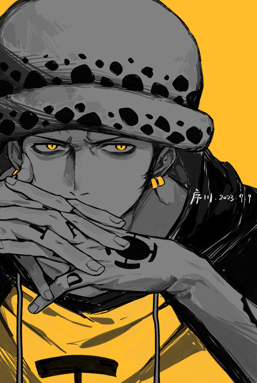1boy arm_tattoo black_hoodie dated drawstring earrings hand_tattoo hat highres hood hoodie jewelry jyukawa looking_at_viewer monochrome one_piece own_hands_together simple_background slit_pupils solo tattoo trafalgar_law two-tone_hoodie upper_body white_hat yellow_background yellow_eyes yellow_hoodie