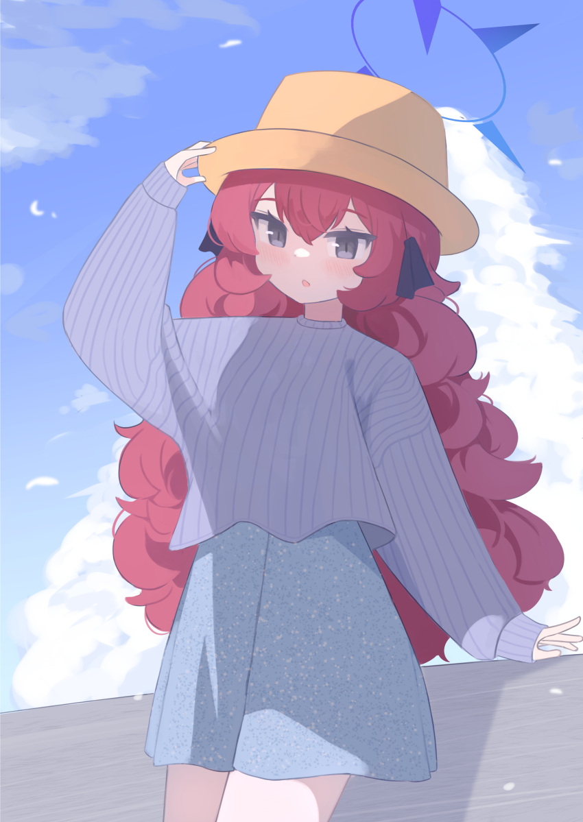 1girl absurdres anma21 blue_archive blue_halo blue_skirt blue_sky blue_sweater blush clouds cowboy_shot cropped_sweater day grey_eyes hair_between_eyes halo hand_on_headwear hat highres iroha_(blue_archive) long_hair long_sleeves outdoors parted_lips redhead skirt sky solo sweater wavy_hair