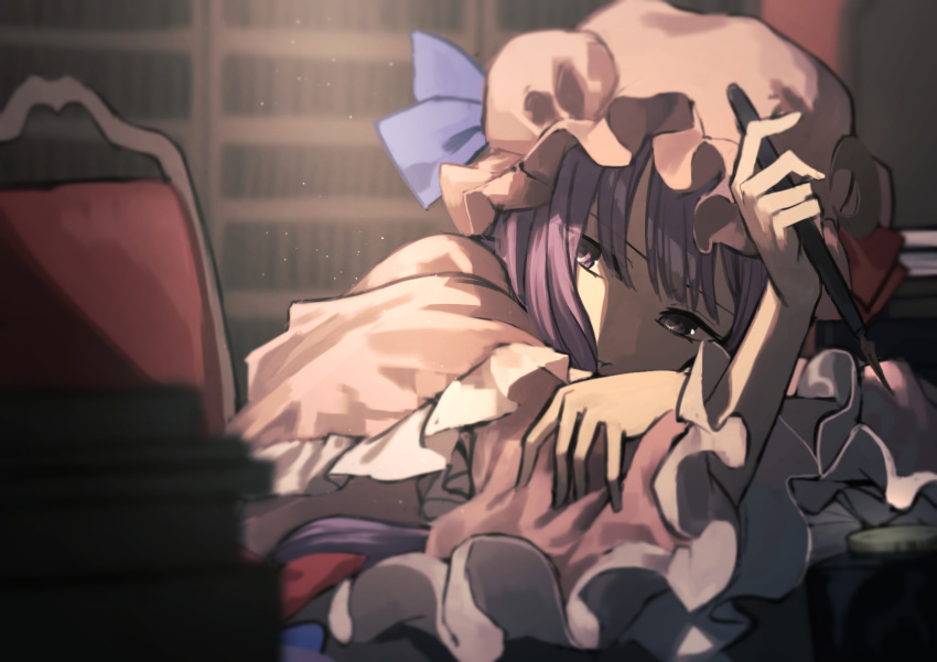 1girl blurry blurry_background book book_stack bookshelf closed_mouth depth_of_field frilled_sleeves frills hand_on_own_arm hat head_tilt highres indoors library mob_cap on_chair otoshiro_kosame patchouli_knowledge pink_hat purple_hair solo touhou violet_eyes wide_sleeves
