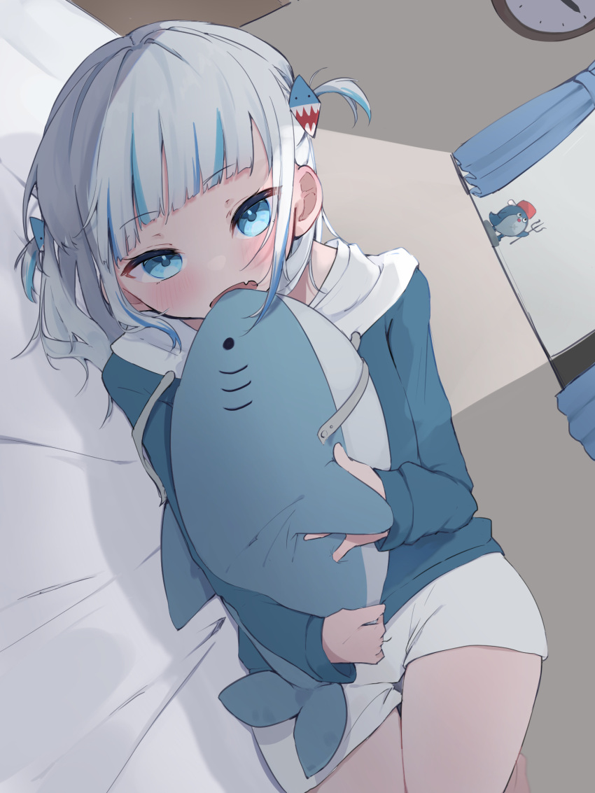 1girl adapted_costume bedroom biting bloop_(gawr_gura) blue_eyes blue_hair blue_hoodie blunt_bangs blush choppy_bangs commentary_request dutch_angle fang gawr_gura gawr_gura_(1st_costume) grey_hair highres hololive hololive_english hood hood_down hoodie indoors long_sleeves looking_at_viewer lying medium_hair multicolored_hair on_bed on_side open_mouth shorts skin_fang solo streaked_hair stuffed_animal stuffed_shark stuffed_toy two_side_up uica virtual_youtuber white_shorts