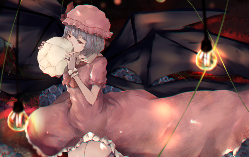 1girl absurdres adapted_costume ascot bat_wings black_wings blurry blurry_background blurry_foreground chromatic_aberration commentary cowboy_shot dress eyebrows_visible_through_hair frilled_dress frilled_hat frills grey_hair hat hat_ribbon highres holding holding_skull kurowa_(curowa) light_bulb long_dress mob_cap pink_dress pink_headwear red_ascot red_eyes red_ribbon remilia_scarlet ribbon short_hair short_sleeves skull solo touhou wings wrist_cuffs