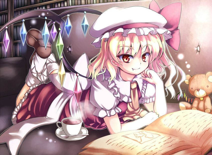 ascot blonde_hair book couch cup dress fang flandre_scarlet fuupu hat legs_up library necktie on_stomach reading red_dress red_eyes side_ponytail smile solo spoon stuffed_animal stuffed_toy teacup teddy_bear the_embodiment_of_scarlet_devil touhou voile wings