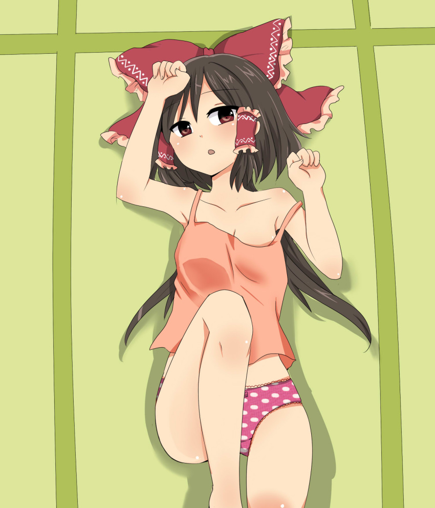 bow brown_eyes brown_hair camisole clenched_fist from_above hair_bow hair_tubes hakurei_reimu highres long_hair looking_at_viewer looking_up lying ochazuke on_back open_mouth panties polka_dot polka_dot_panties solo touhou underwear underwear_only