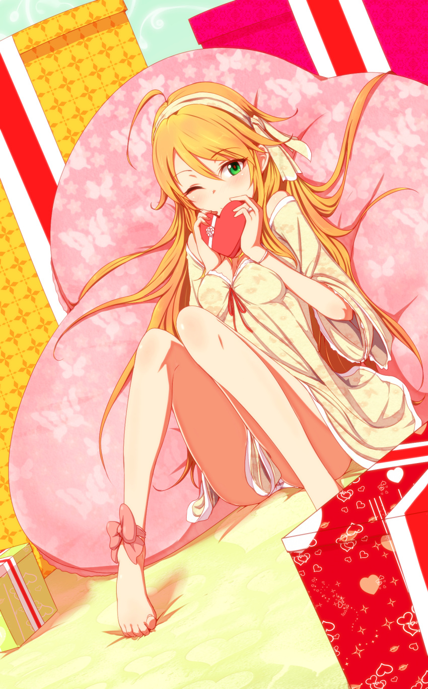 ahoge ankle_ribbon bare_legs barefoot blonde_hair chocolate dress feet gift green_eyes hairband heart highres hoshii_miki idolmaster legs long_hair looking_at_viewer pillow shirihime smile solo toe-point valentine wink