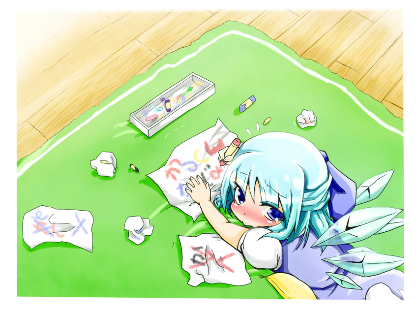 blue_dress blue_eyes blue_hair blush box chalk cirno crayon dress flying_sweatdrops from_above hair_ribbon highres looking_at_viewer looking_back looking_up lying nari0518 on_stomach outstretched_arm paper pillow puffy_sleeves ribbon rug short_hair short_sleeves solo tears touhou wings wooden_floor writing