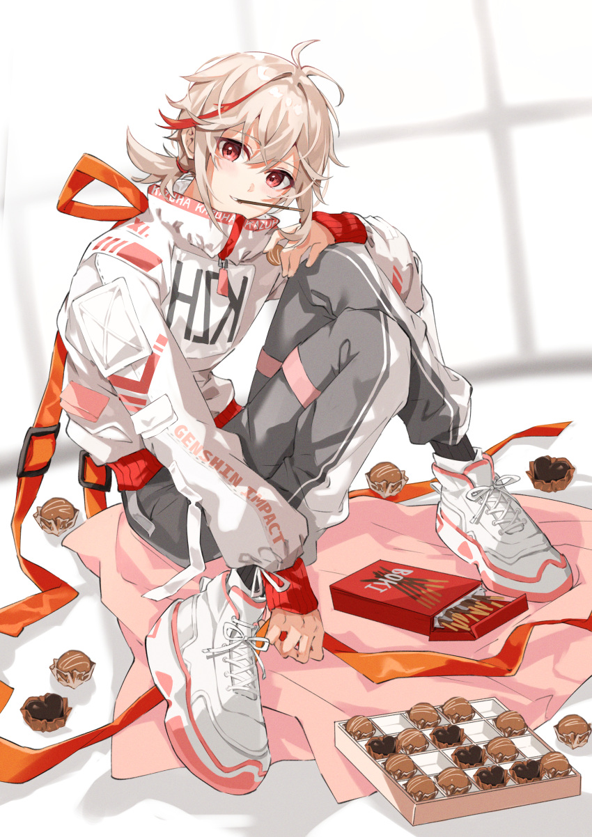 1boy absurdres alternate_costume bangs candy chocolate clothes_writing fashion food food_in_mouth full_body genshin_impact grey_hair hair_between_eyes highres jacket kaedehara_kazuha long_sleeves male_focus mouth_hold multicolored_hair pants pocky pocky_in_mouth ponytail red_eyes redhead shoes sitting sneakers solo yuitonoel