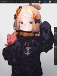  1girl abigail_williams_(fate/grand_order) alternate_hairstyle bandaid_on_forehead bangs belt black_bow black_jacket blonde_hair blue_eyes blush bow fate/grand_order fate_(series) forehead hair_bow hair_bun hand_up high_collar highres holding holding_stuffed_animal jacket long_hair looking_at_viewer misekai_555 open_mouth orange_bow parted_bangs polka_dot polka_dot_bow sleeves_past_fingers sleeves_past_wrists solo stuffed_animal stuffed_toy teddy_bear 