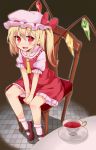  1girl ascot blonde_hair blush chair cup dark_skin dress flandre_scarlet hat hat_ribbon looking_at_viewer makai_penguin open_mouth puffy_sleeves red_dress red_eyes ribbon shirt short_sleeves side_ponytail sitting smile solo table teacup touhou v_arms wings 