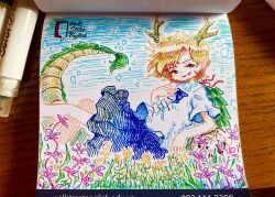  1girl absurdres antlers art_tools_in_frame blonde_hair blue_shirt blue_skirt commentary_request dragon_girl dragon_horns dragon_tail fur-tipped_tail green_scales green_tail highres horns kicchou_yachie looking_at_viewer open_mouth photo_(medium) shirt short_sleeves skirt smile solo spiked_shell suteruko tail touhou traditional_media turtle_shell yellow_eyes yellow_horns 