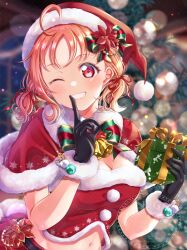  1girl alternate_costume bell black_gloves blurry blurry_background box breasts christmas dress gift gift_box gloves hat highres holding iroenpitsu_xxx long_hair looking_at_viewer love_live! love_live!_sunshine!! medium_breasts navel neck_bell one_eye_closed orange_eyes orange_hair santa_costume santa_dress santa_hat smile solo takami_chika teeth tree_costume upper_body watermark 