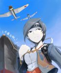  1girl airplane black_eyes black_hair bomb chitose_(kantai_collection) clenched_hand headband hetza_(hellshock) japanese_clothes kantai_collection pale_skin personification ship solo tassel turret 