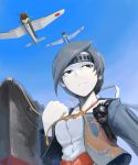  1girl airplane black_eyes black_hair bomb chitose_(kantai_collection) clenched_hand headband hetza_(hellshock) japanese_clothes kantai_collection pale_skin personification ship solo tassel turret 