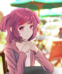  1girl :/ artist_name blurry blurry_background bob_cut cafe casual chair closed_mouth collarbone commentary doki_doki_literature_club elbow_rest folding_chair from_side hair_rings highres hood hood_down hoodie interlocked_fingers leguma long_sleeves looking_at_viewer looking_to_the_side natsuki_(doki_doki_literature_club) open_clothes open_hoodie outdoors own_hands_together patio_umbrella pink_eyes pink_hair pink_hoodie pov raised_eyebrow red_ribbon ribbon shirt short_hair solo swept_bangs table twitter_username two_side_up upper_body white_shirt wooden_chair 