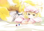  1girl blonde_hair dress fox_tail hat hat_with_ears long_sleeves looking_at_viewer lying multiple_tails on_stomach sinzan smile solo tabard tail touhou white_dress yakumo_ran yellow_eyes 