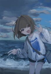  1girl :d ahoge beach black_eyes blue_sky blunt_bangs bob_cut brown_hair charm_(object) clouds cloudy_sky commentary_request cowboy_shot crossbody_bag deathguntank dolphin_shorts fang hair_intakes highres long_sleeves looking_at_viewer medium_hair ocean open_mouth original print_sweater sand shorts skin_fang sky smile solo sweater v waves waving 