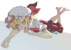  1girl :d absurdres bare_arms bare_legs barefoot blonde_hair blush cellphone commentary_request crossed_ankles crystal_wings fang feet_up flandre_scarlet frilled_hat frills hat highres looking_at_viewer lying on_stomach phone pointy_ears puffy_short_sleeves puffy_sleeves red_skirt red_vest seika_okawari shirt short_sleeves skin_fang skirt skirt_set slit_pupils smile soles solo touhou vest white_hat white_shirt wings 
