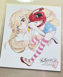  1girl backpack bag blonde_hair blush charm_(object) commentary_request crop_top flat_chest full_body highres kodomo_no_jikan kokonoe_rin kumamon long_hair looking_at_viewer one_eye_closed photo_(medium) randoseru shikishi shoes short_shorts shorts smile solo striped_clothes striped_thighhighs thigh-highs traditional_media twintails uwabaki v watashiya_kaworu 