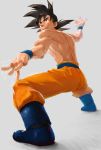  1boy black_hair boots brown_eyes dragon_ball dragon_ball_z highres male muscle open_mouth saiyan shirtless smile solo son_gokuu stance wristband 