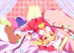  1girl ascot blonde_hair blush elbow_gloves fang flandre_scarlet gloves hat highres lying on_back open_mouth pillow red_eyes short_hair side_ponytail skirt solo stuffed_animal stuffed_toy teddy_bear touhou yuimari 