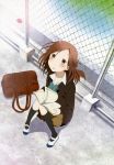  1girl :o absurdres bag black_legwear book brown_eyes brown_hair chain-link_fence fujimiya_kaori highres isshuukan_friends kneehighs nyantype official_art open_book school_bag school_uniform shoes socks sweater uwabaki 